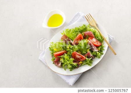 Tomato, prosciutto and leaf lettuce salad Tomato, prosciutto and leaf lettuce salad 125005767