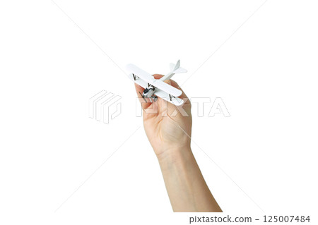 A hand holds a small white airplane, symbolizing vacation, isolated on white 125007484