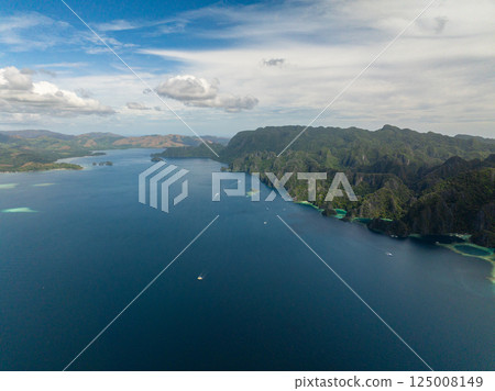 Boat over the blue sea. Coron Island with limestone mountain. Palawan, Philippines. 125008149