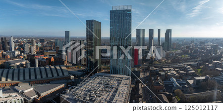 Aerial view of Manchester, UK, showcasing Beetham Tower, modern skyscrapers, historic architecture, and the Manchester Central Convention Complex. 125012117