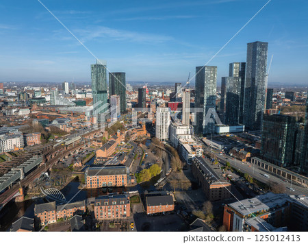 Aerial view of Manchester, UK, featuring the modern skyline with Beetham Tower, high rise buildings, River Irwell, bridges, and historic architecture. 125012413
