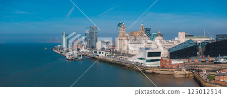 Aerial view of Liverpool's waterfront along the River Mersey, featuring the Royal Liver Building, Port of Liverpool Building, and Museum of Liverpool. Aerial view of Liverpool's waterfront along the River Mersey, featuring the Royal Liver Building, Port of Liverpool Building, and Museum of Liverpool. 125012514