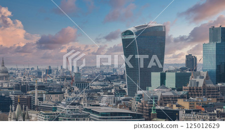 Aerial view of London showcasing the Walkie Talkie building, St. Paul's Cathedral, modern skyscrapers, and a sprawling urban landscape under a clear sky. 125012629