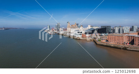 Aerial view of Liverpool's waterfront along the River Mersey, featuring the Royal Liver Building, Museum of Liverpool, and historic Albert Dock. Aerial view of Liverpool's waterfront along the River Mersey, featuring the Royal Liver Building, Museum of Liverpool, and historic Albert Dock. 125012698