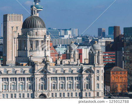 Aerial view of Liverpool showcasing the Port of Liverpool Building, Radio City Tower, and a mix of modern and historic architecture, including red brick structures. Aerial view of Liverpool showcasing the Port of Liverpool Building, Radio City Tower, and a mix of modern and historic architecture, including red brick structures. 125012788