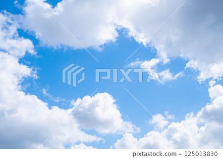 A hole in the middle of a cloud showing the sky A hole in the middle of a cloud showing the sky 125013830