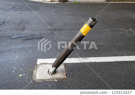 A car stopper that was bent after being hit by a car A car stopper that was bent after being hit by a car 125013837