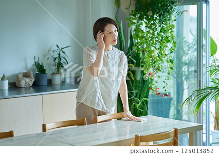 A woman suffering from a headache 125013852
