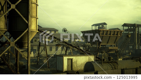 Old industrial site with silos and machinery in a desolate landscape Old industrial site with silos and machinery in a desolate landscape 125013995