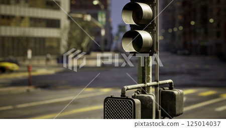 Traffic lights at a quiet intersection in an urban setting during dawn 125014037
