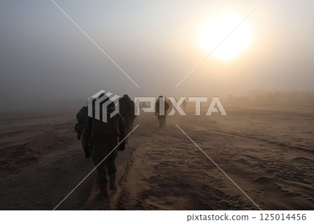 Group of infantrymen patrol area unwavering watching for signs of potential threats. The infantrymen patrol with determination, scanning for any signs of danger in the area. 125014456