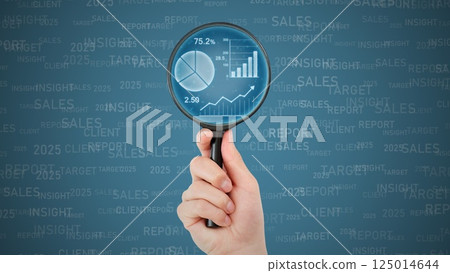 Hands doing research using a magnifying glass 125014644