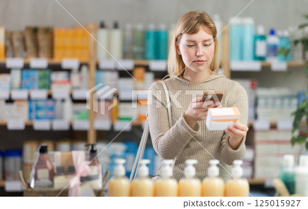 Young woman scanning qr code of pills Young woman scanning qr code of pills 125015927