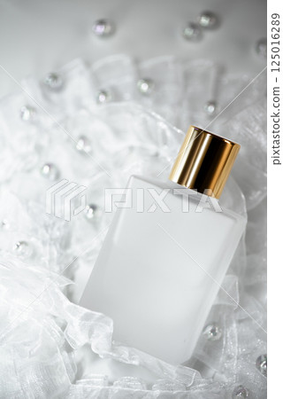 White frills, beads and gold cap cosmetic bottle 125016289