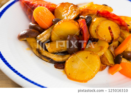 Delicious fried potatoes with shitake mushrooms and sausage 125016310