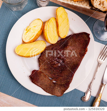 Delicious roasted veal chop served with potato Delicious roasted veal chop served with potato 125016320