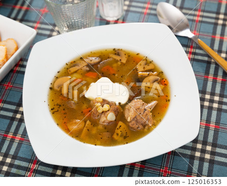 Rustic style mushroom soup with pork, vegetables and sour cream 125016353
