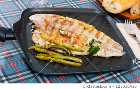Delicious grilled bass with asparagus Delicious grilled bass with asparagus 125016416