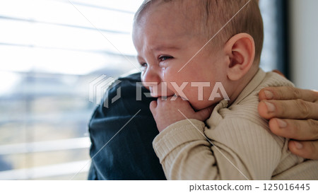 Father comforting his crying baby son. 125016445