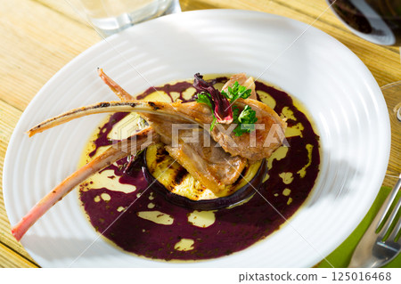 Lamb ribs served with slice of eggplant 125016468