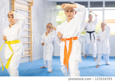 Young karate students gather in dojo 125016765