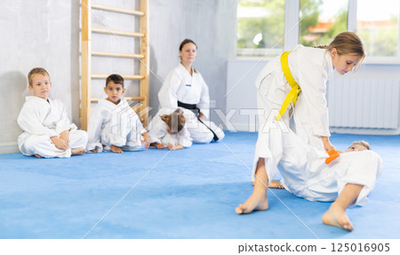 Karate students engage in sparring Karate students engage in sparring 125016905