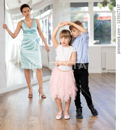 Preteen girl and boy practicing samba in latin dance studio 125017137