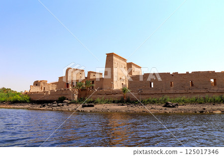 Temple of Isis on Agilkia Island (Philae) near to reservoir of Aswan Low Dam, Egypt. View from Nile River. Topic of vacation, travel, trip abroad on vacation, cruises and tours Temple of Isis on Agilkia Island (Philae) near to reservoir of Aswan Low Dam, Egypt. View from Nile River. Topic of vacation, travel, trip abroad on vacation, cruises and tours 125017346