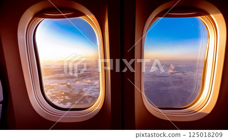 view from airplane window, inside an airplane, the window at the wing and a vast expanse of fluffy white clouds under a clear blue sky during daytime, looking out airplane, flying above clouds view from airplane window, inside an airplane, the window at the wing and a vast expanse of fluffy white clouds under a clear blue sky during daytime, looking out airplane, flying above clouds 125018209