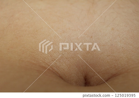 A close-up of the navel on the abdomen. Types of navels A close-up of the navel on the abdomen. Types of navels 125019395