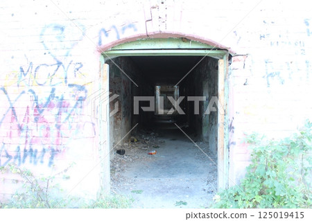 Tunnel corridor in an abandoned building. Destroyed houses Tunnel corridor in an abandoned building. Destroyed houses 125019415