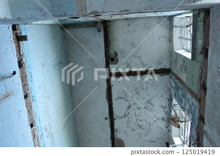 An old ruined house with collapsed stairs and floor slabs An old ruined house with collapsed stairs and floor slabs 125019419
