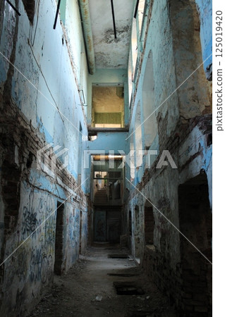 A dark corridor in an abandoned building. Destroyed houses A dark corridor in an abandoned building. Destroyed houses 125019420