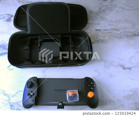 Mozyr, Belarus, March 16 2024: Nintendo Switch Game Console Controller with Black Case Top View Mozyr, Belarus, March 16 2024: Nintendo Switch Game Console Controller with Black Case Top View 125019424