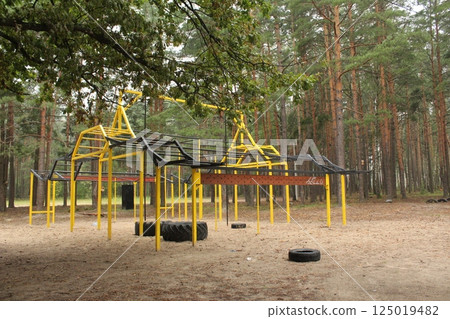 Sports metal equipment in the forest. Outdoor activities Sports metal equipment in the forest. Outdoor activities 125019482