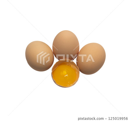 Light brown organic raw chicken eggs with yolk in package isolated on white background. Light brown organic raw chicken eggs with yolk in package isolated on white background. 125019956