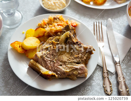 Grilled pork meat with roasted potatoes and braised cabbage 125020739
