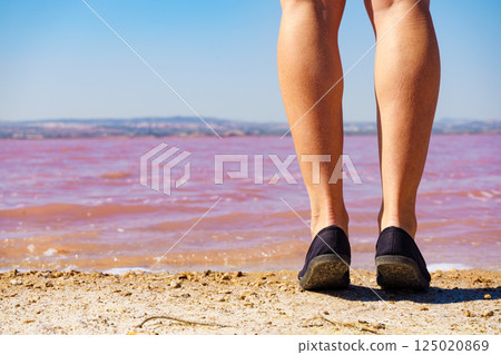 Woman on pink lake in Spain Woman on pink lake in Spain 125020869