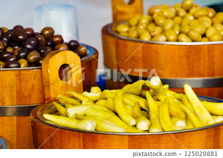 Olives and peppers for sale at market 125020881