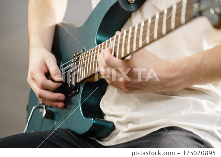Close up of man playing on electric guitar Close up of man playing on electric guitar 125020895