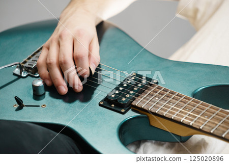 Close up of man playing on electric guitar Close up of man playing on electric guitar 125020896