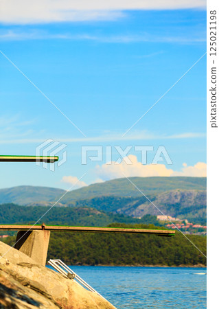 View of diving board. Springboard to dive at water. 125021198