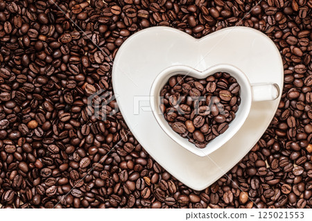 cup and saucer on coffee beans background 125021553