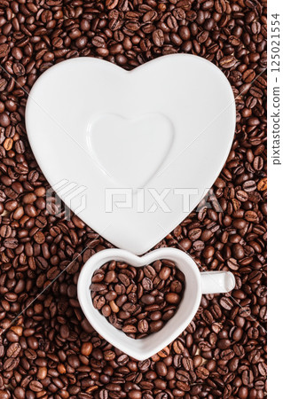 cup and saucer on coffee beans background 125021554