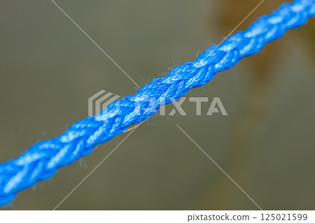 Detailed closeup of thick blue rope Detailed closeup of thick blue rope 125021599
