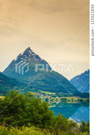 Reflection of mountains in norwegian fjord lake Reflection of mountains in norwegian fjord lake 125021650