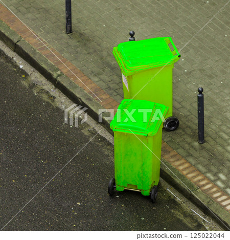 Plastic wheely bins in the street outside Plastic wheely bins in the street outside 125022044