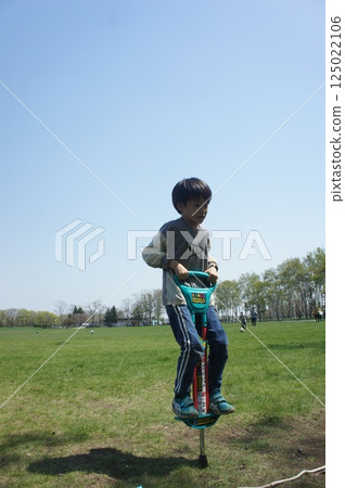 Boy playing with hopping board Boy playing with hopping board 125022106