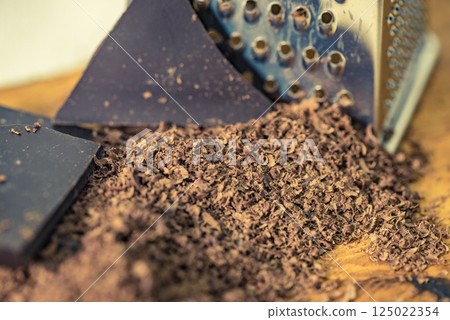 Grater and grated chocolate closeup 125022354