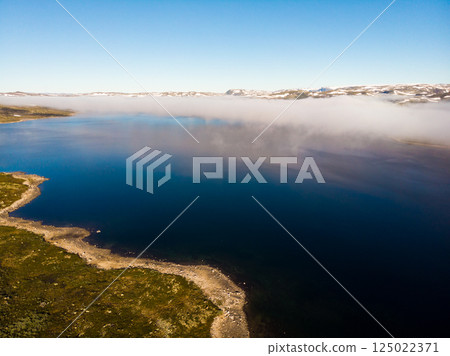 Clouds over lake water, Hardangervidda landscape, Norway 125022371